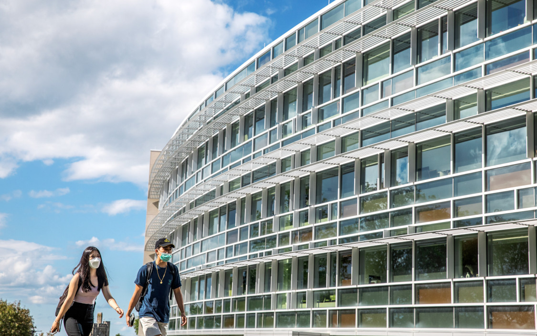 Students walk past the Cornell Health services building