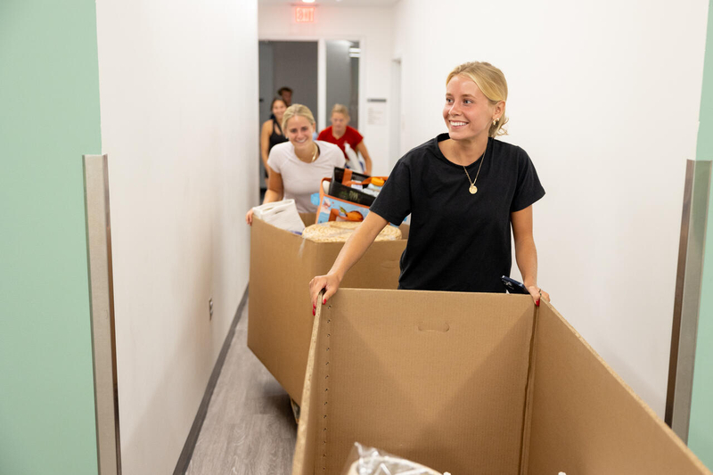 Students with carboard boxes