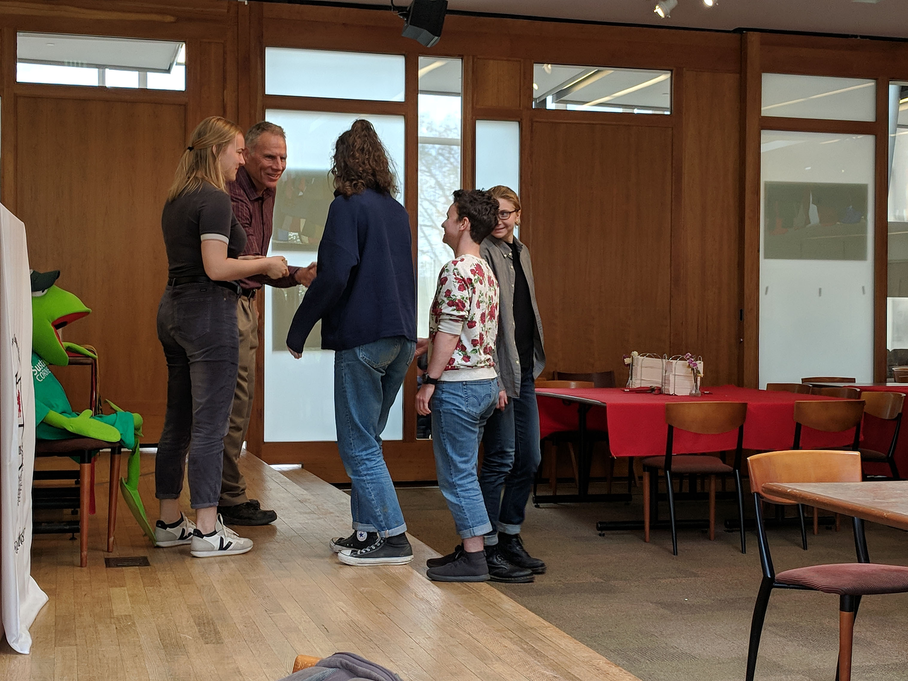 Man hands out awards to students