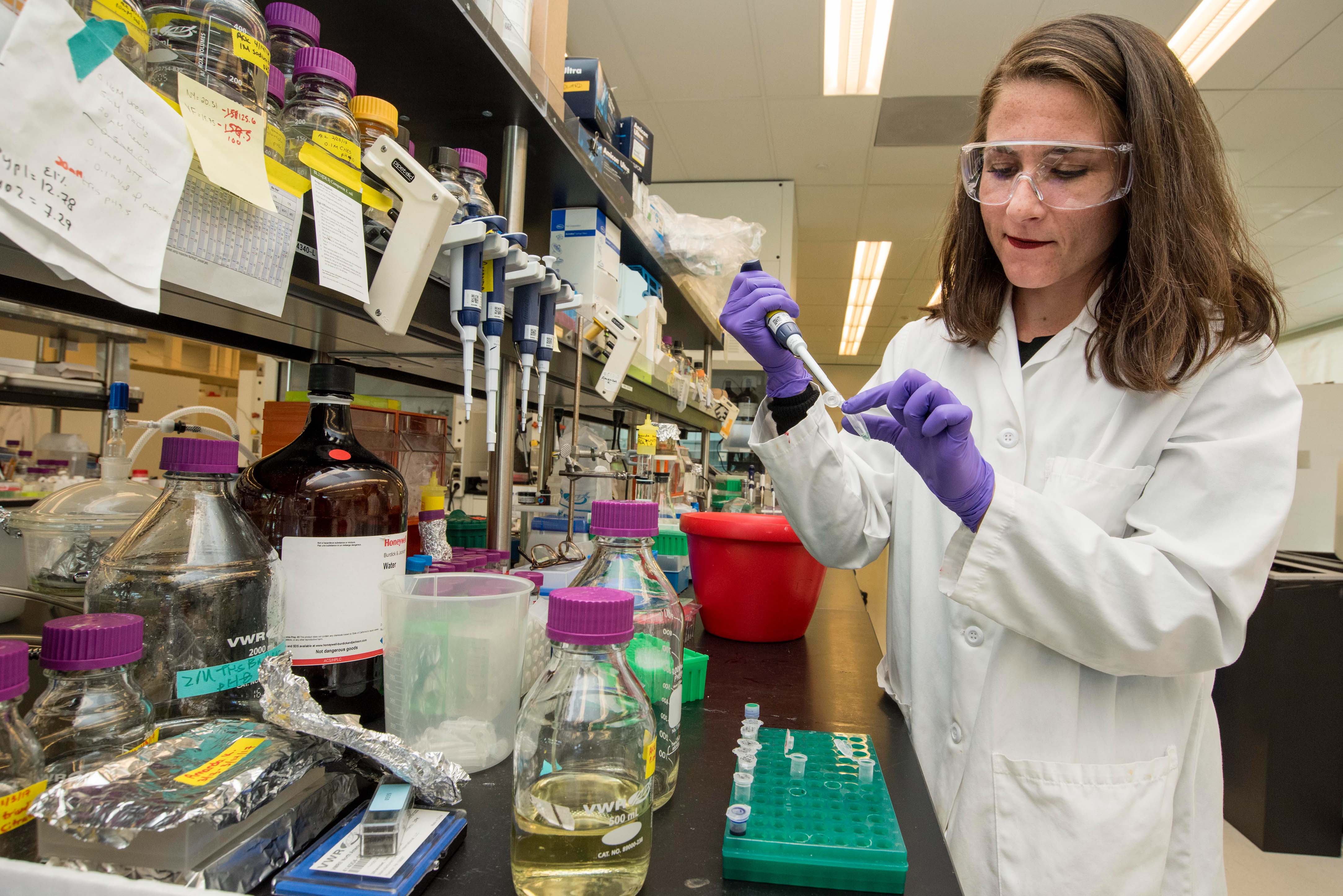 Woman holding pipette in lab