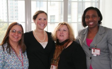Five women of the Weill Cornell green team smile for the camera