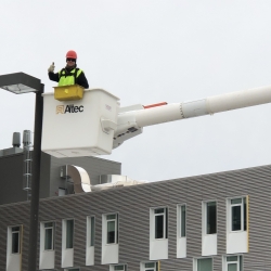 Staff installing LED street light