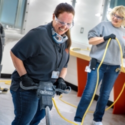 Custodian Patty Armstrong runs a rotary scrubber