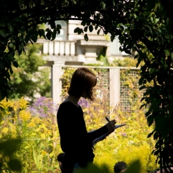 Student reading beneath Cornell archway