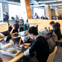 Students sitting in Statler Hall reading by a window
