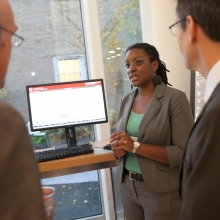 Energy Outreach Coordinator Erin Moore shows off one of the Human Ecology Building's energy usage dashboards.