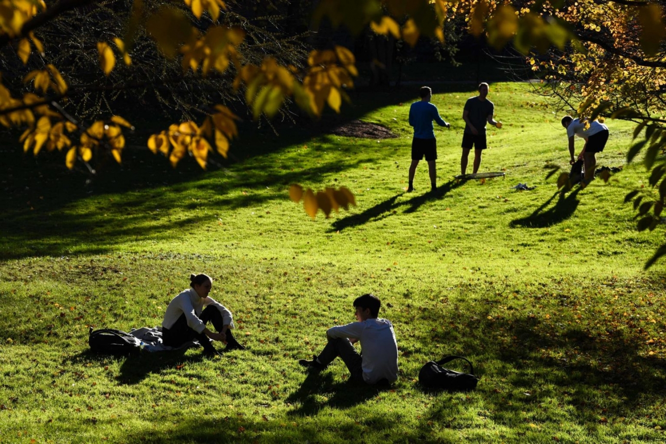 Students relax in the clearing by Sage Hall after class in October.