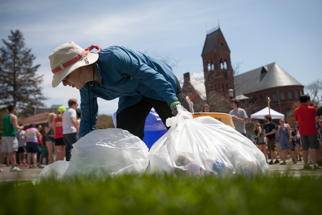 Picking up water bottles to recycle them on Slope Day